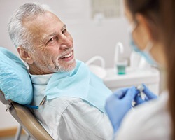 Patient smiling at dental team member