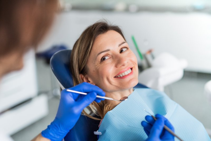 person’s hand circling the word “dentist” on calendar