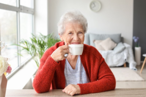 Senior woman drinking tea and smiling